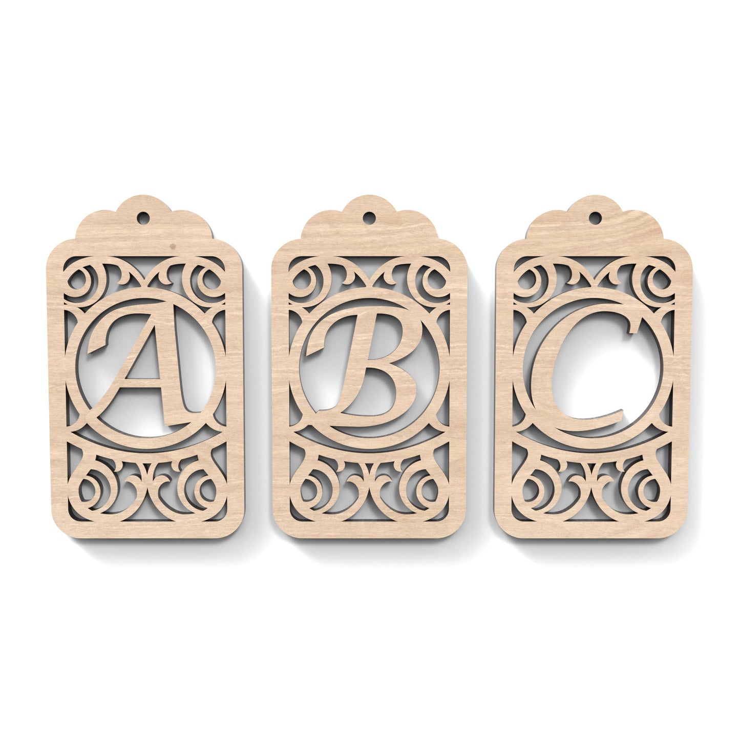 A B C of Monogram Gift Tags made from our laser cutting files and available as a digital download. Each gift tag features a separate letter cut out of its centre.
