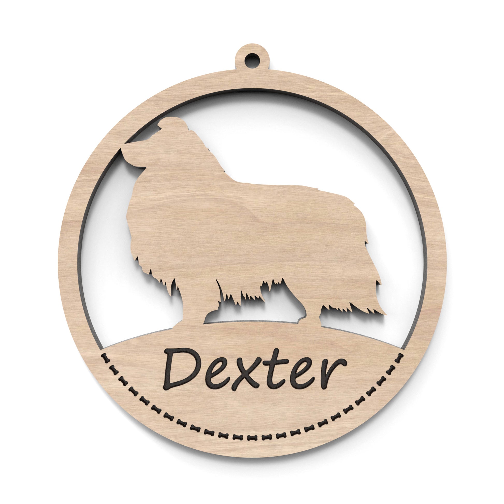 A dog ornament bauble made from our laser cutting files and available for digital download. Each ornament features a circular bauble shape with a silhouette of your favourite dog breed in the centre and a space at the bottom for personalization.