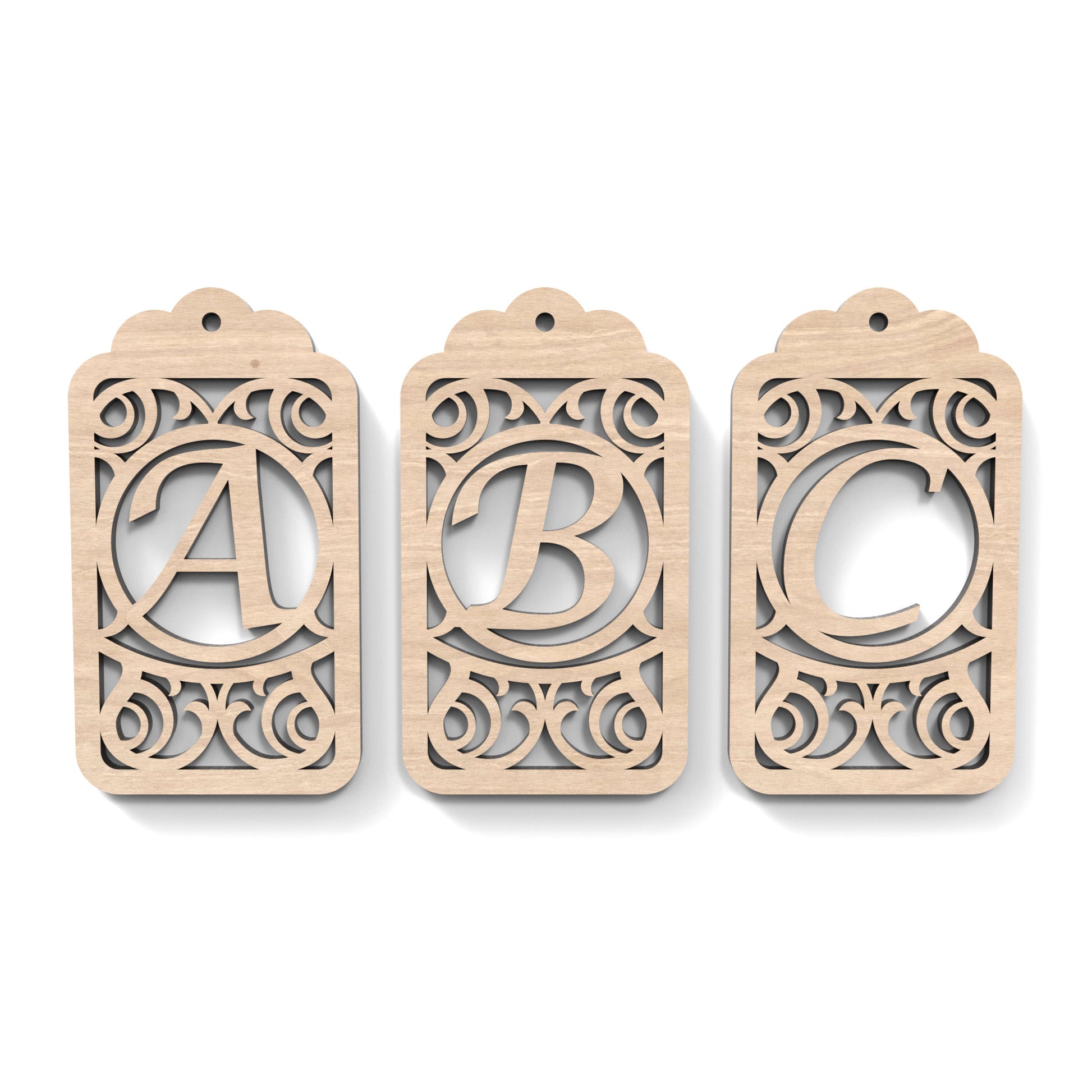 A B C of Monogram Gift Tags made from our laser cutting files and available as a digital download. Each gift tag features a separate letter cut out of its centre.