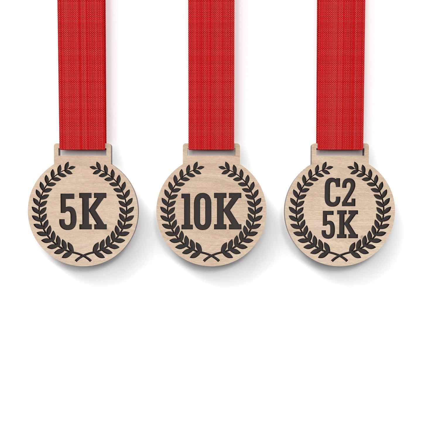 Set of 3 running medals made from our laser cutting files and available for digital download. Each medal is 6cm wide with a slot for a 2.5cm ribbon at the top and features engraving for 5K, 10K, C25K.