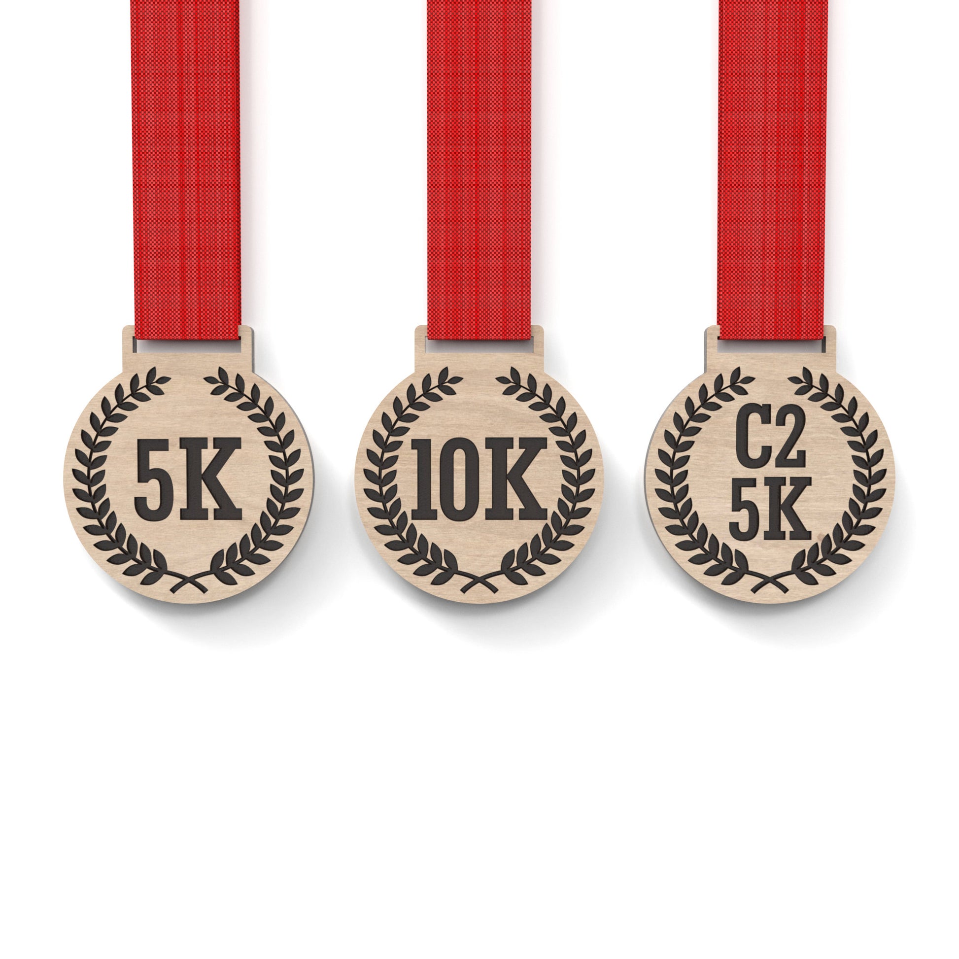 Set of 3 running medals made from our laser cutting files and available for digital download. Each medal is 6cm wide with a slot for a 2.5cm ribbon at the top and features engraving for 5K, 10K, C25K.