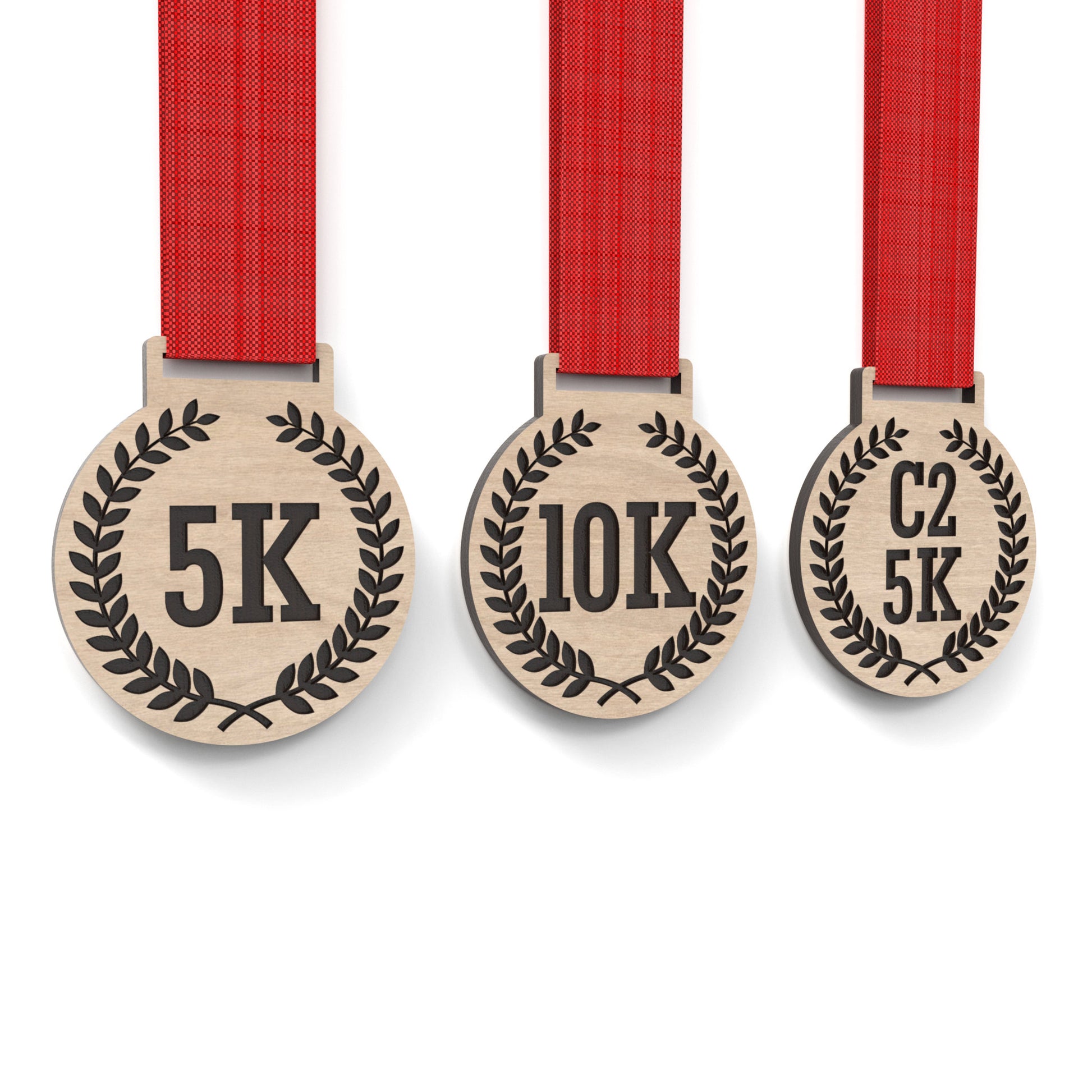 Set of 3 running medals made from our laser cutting files and available for digital download. Each medal is 6cm wide with a slot for a 2.5cm ribbon at the top and features engraving for 5K, 10K, C25K.